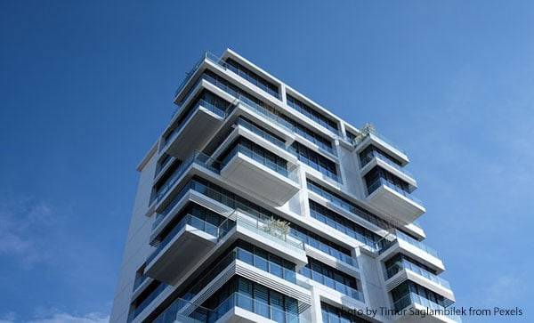houses-building-600x condo hi rise against blue sky